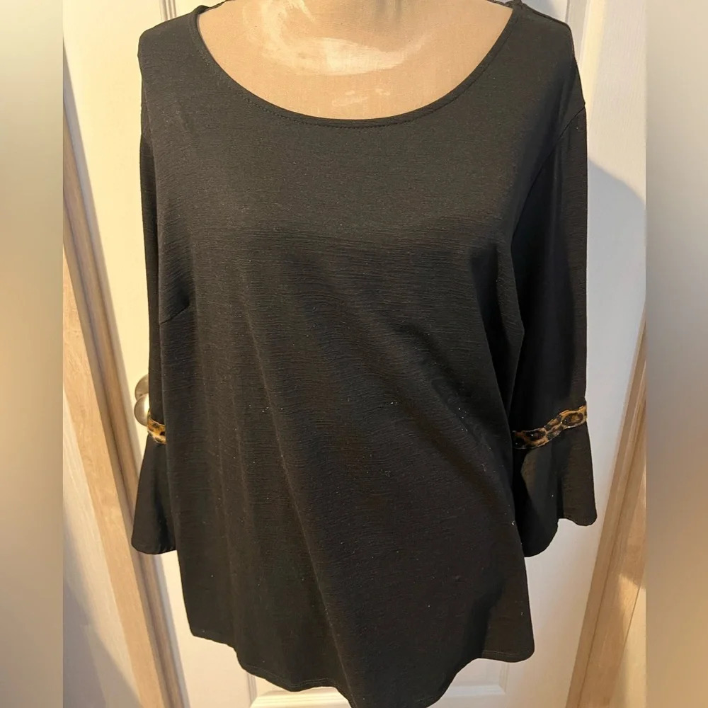 AGB woman 2X black long sleeve top with leopard print design on sleeves.